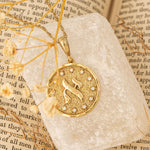 Aleph pendant resting on stone tile over Hebrew text