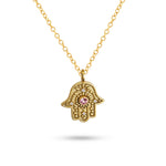 Studio view of gold Eternal Pulse Hamsa necklace on a white background.