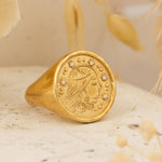 Sarah Ring placed on stone surface with dried botanicals