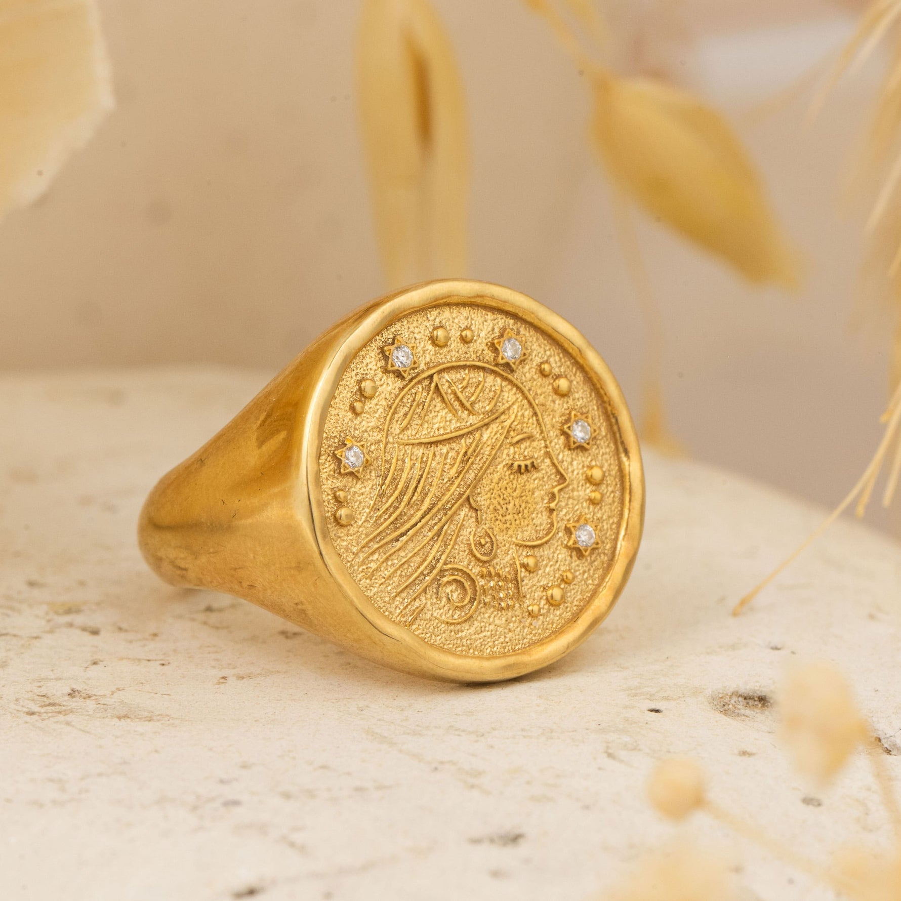 Sarah Ring placed on stone surface with dried botanicals