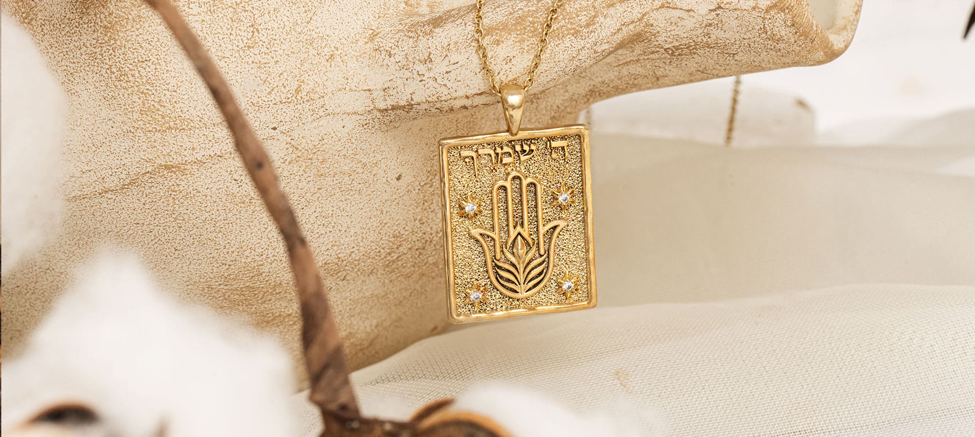 Rectangular gold pendants engraved with Psalms verses from The Psalms Collection by Sages & Souls, styled on old script background
