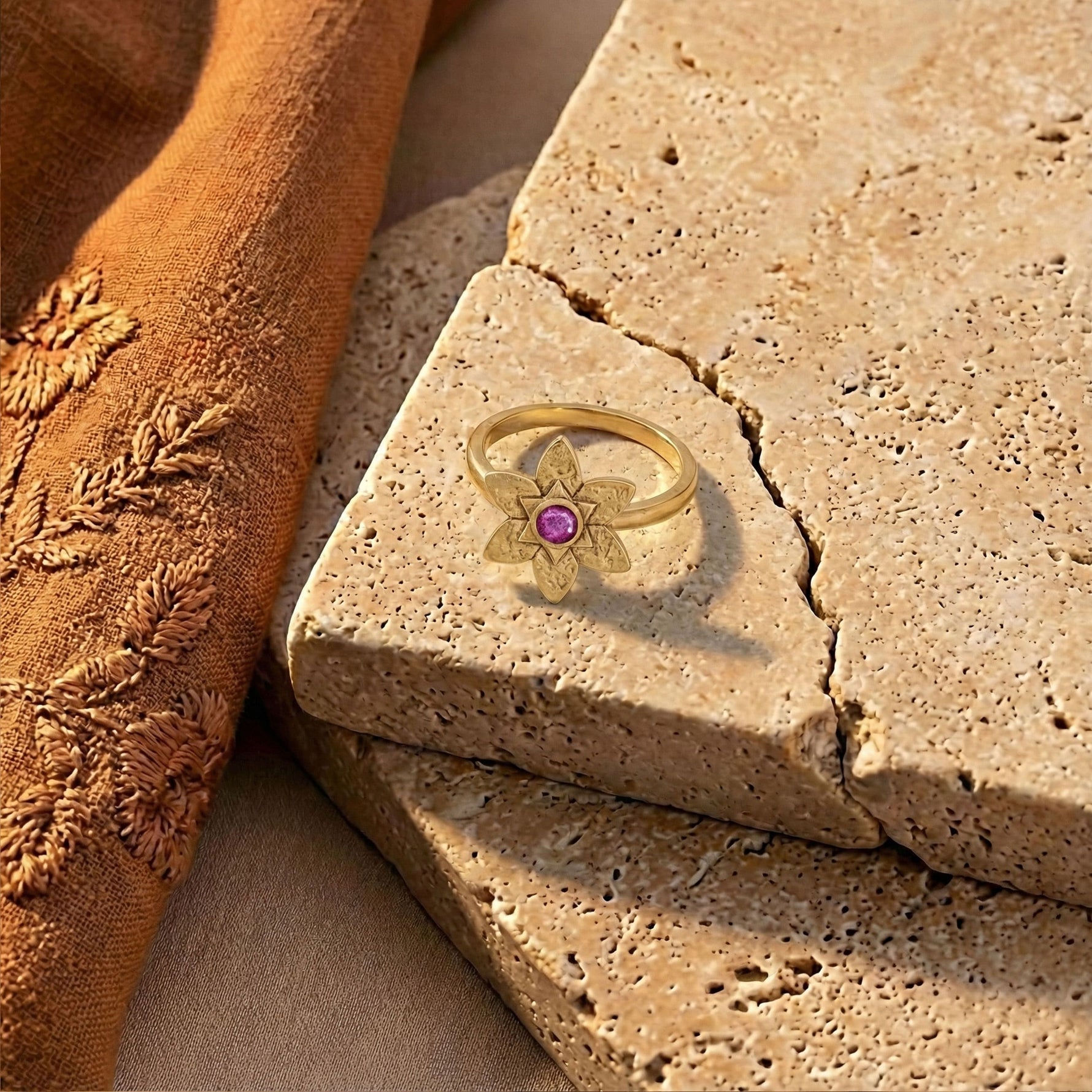 Petal Star of David Ring in 18K Gold Vermeil with pink sapphire displayed on textured stone