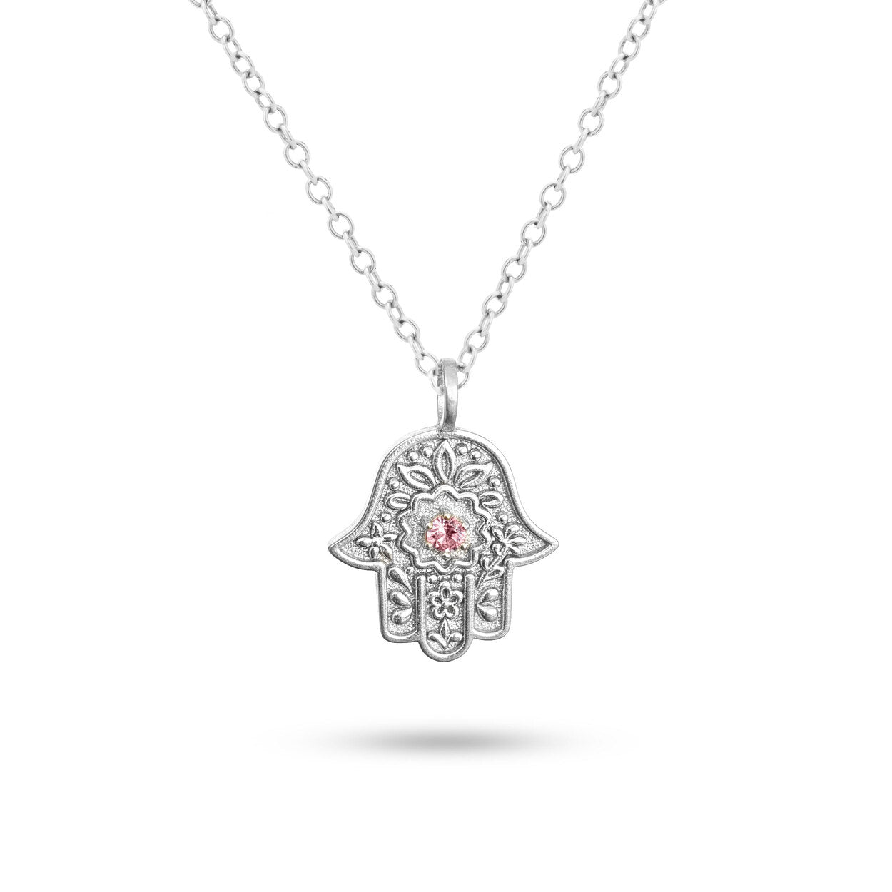 Detailed view of the embossed floral motif on the silver Garden of Grace Hamsa.