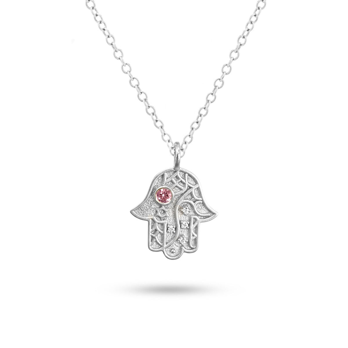 Studio view of silver Vine of Lineage Hamsa necklace on a white background.