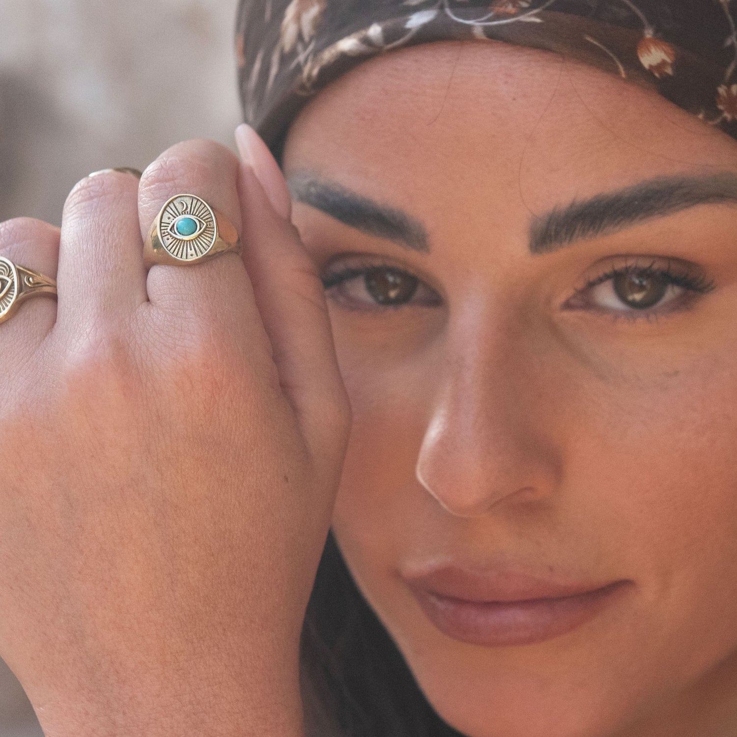 Model wearing Divine Eye Ring in head wrap, captured in warm natural light