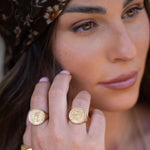Model wearing Leah Ring on two fingers, with a modern Jewish head covering, styled with cozy outfit and layered jewelry