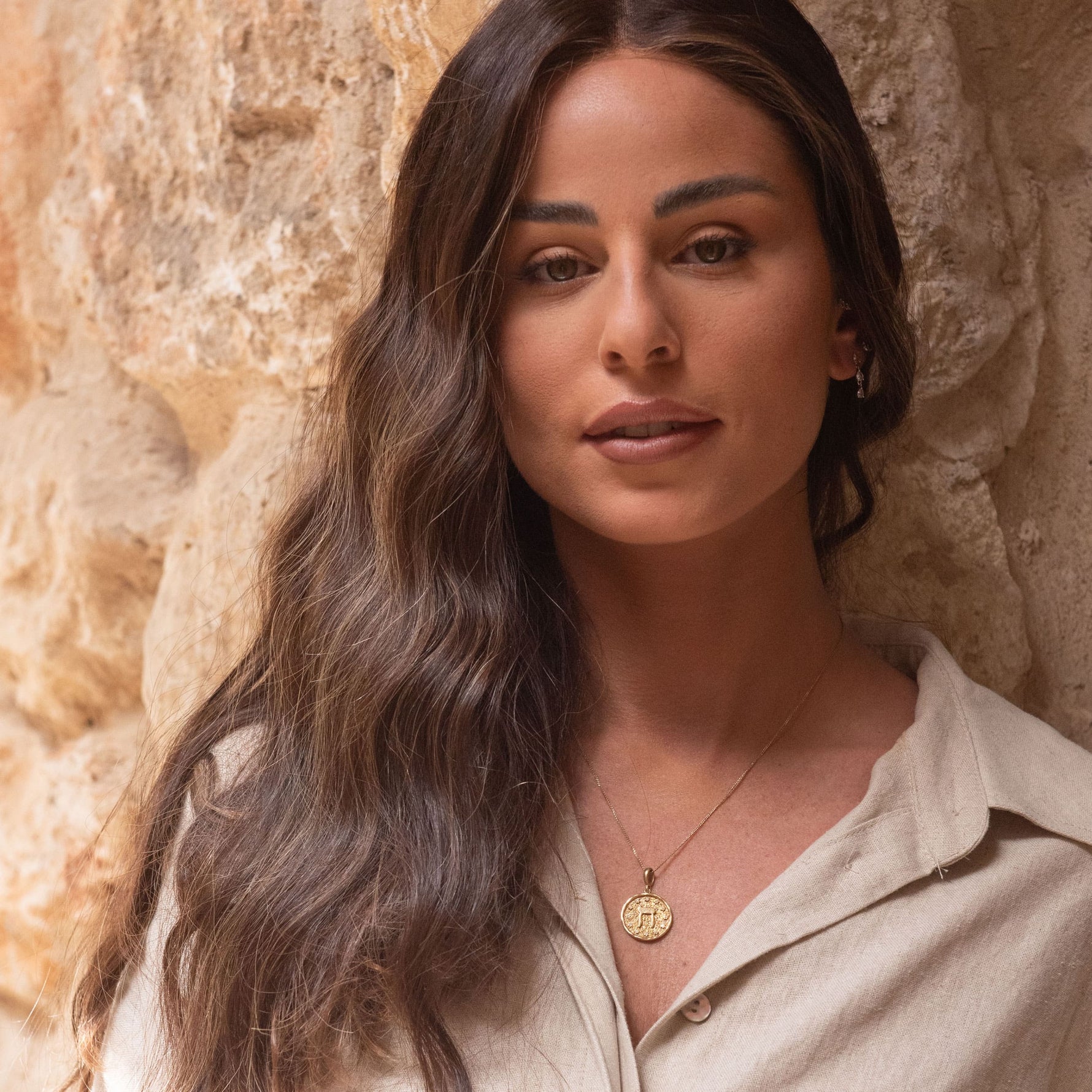 Chet Pendant worn by model in natural light against ancient stone wall – meaningful Hebrew letter necklace by Sages & Souls
