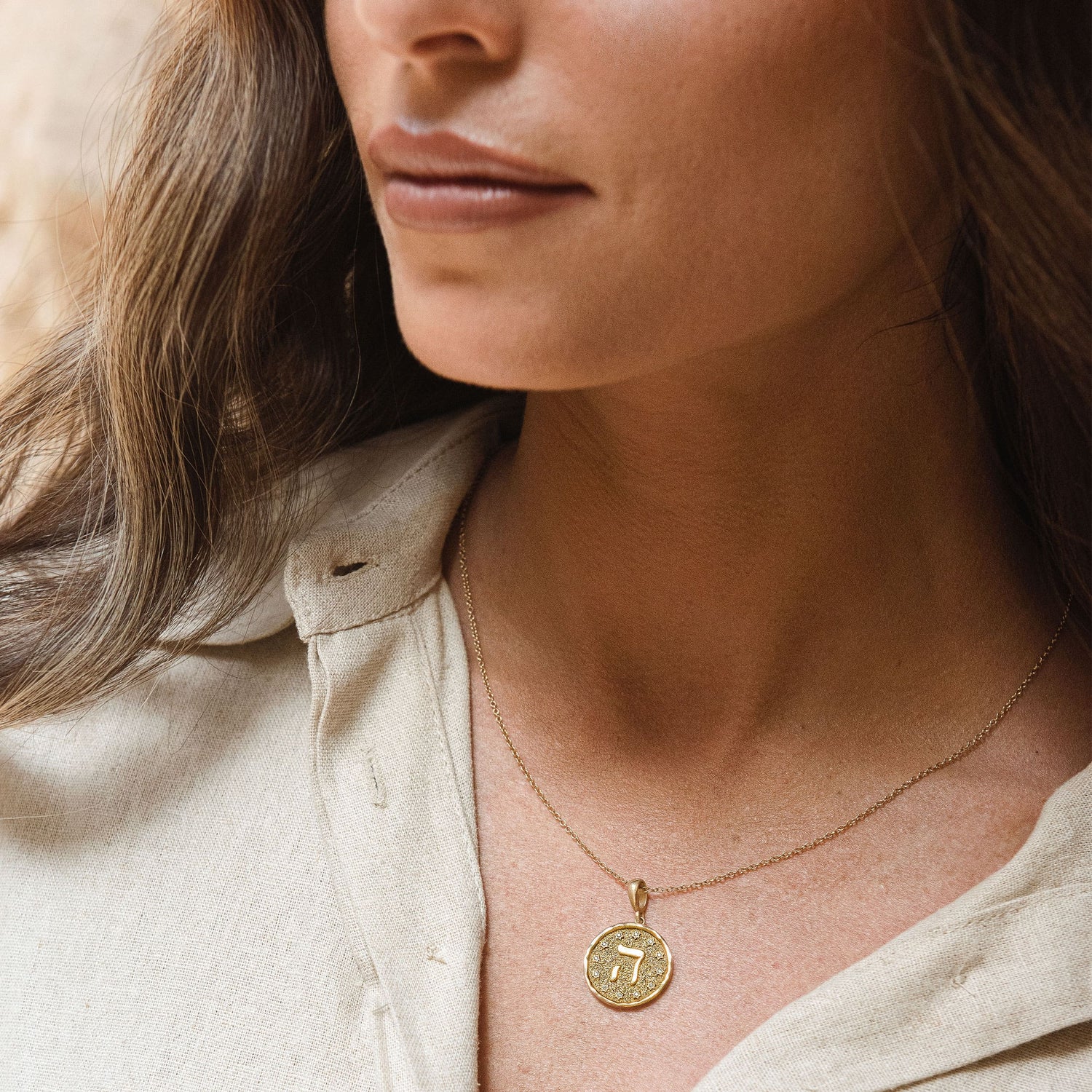 Model wearing letter Hey pendant layered necklaces