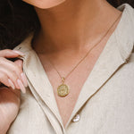Close portrait of model touching Shin pendant necklace