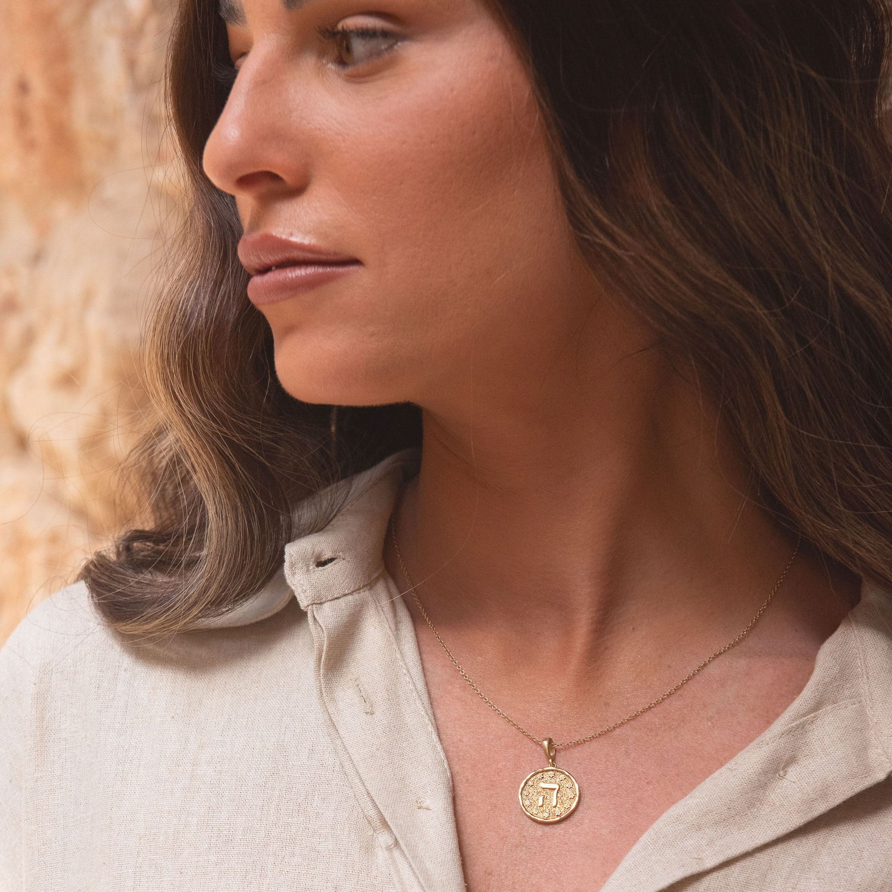 Model wearing Hebrew letter Hey pendant with layered gold necklaces – spiritual Judaica jewelry