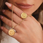 Model wearing Rebecca Ring stacked with other rings, hand styled near face