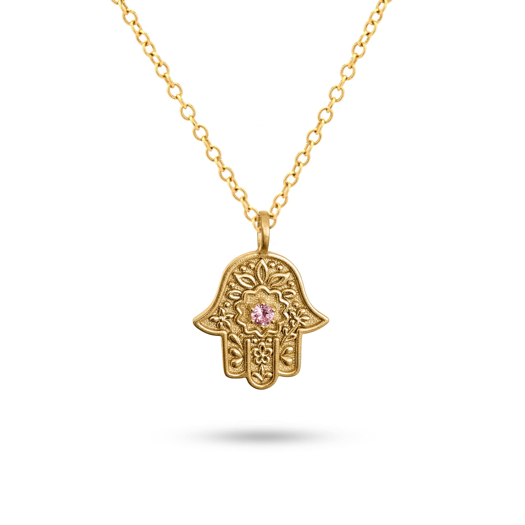 Detailed view of the embossed floral motif on the gold Garden of Grace Hamsa.