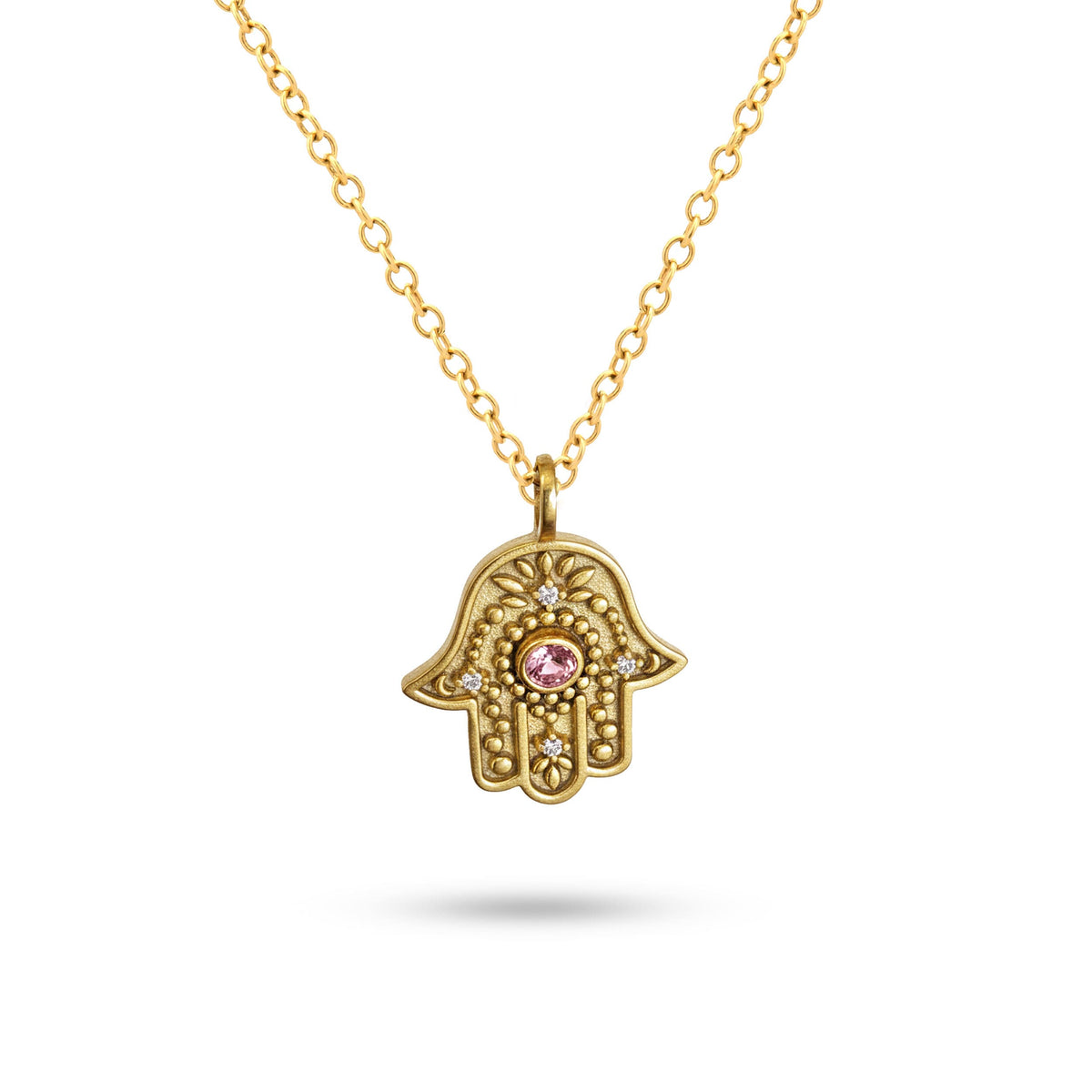 Studio view of gold Eternal Pulse Hamsa necklace on a white background.