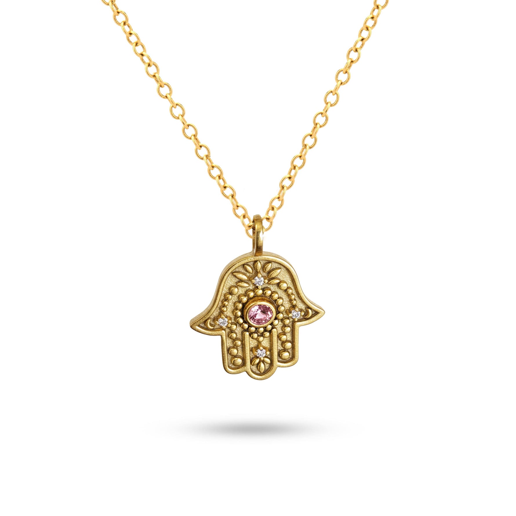 Studio view of gold Eternal Pulse Hamsa necklace on a white background.