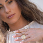 Model’s hands displaying סאל pendant and rings