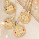 Three סאל pendants with rubies on linen flat lay