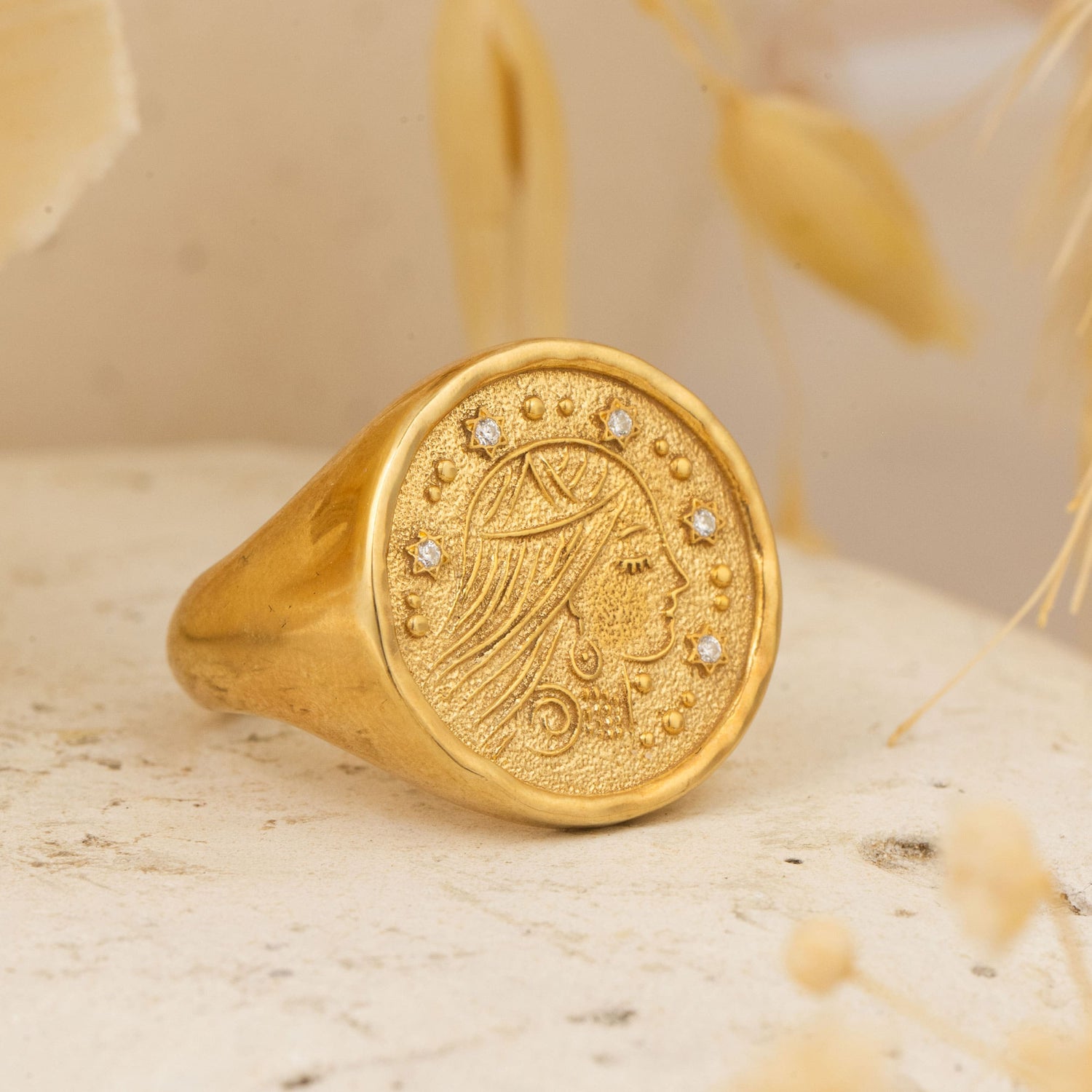 Sarah Ring placed on stone surface with dried botanicals