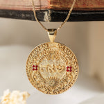 שאה pendant hanging on wooden book spine dried flowers