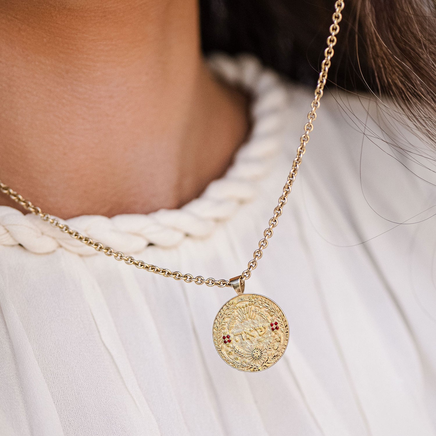 Model wearing שאה pendant over pleated blouse