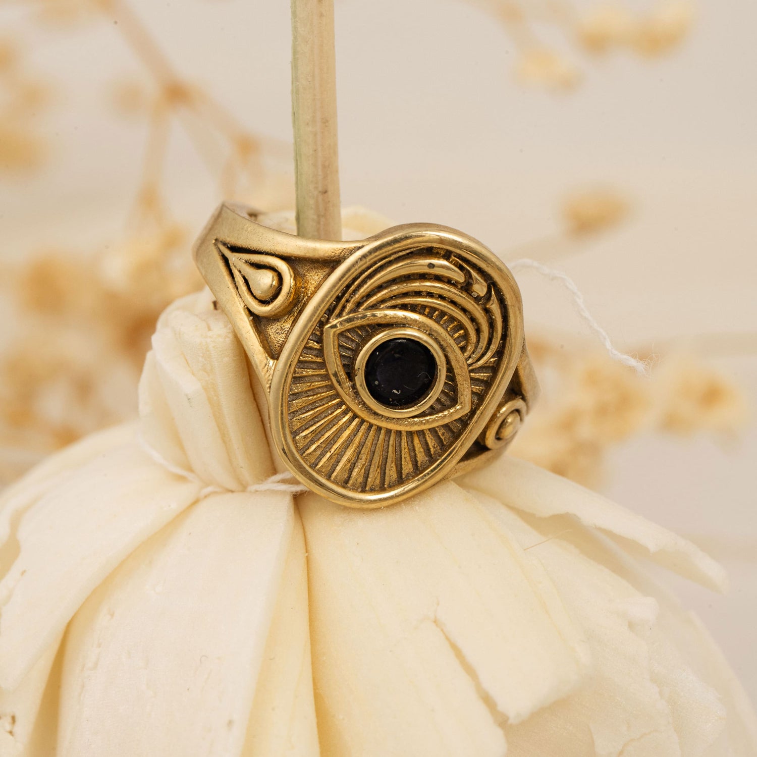  Window to the Soul gold ring with black stone displayed on dried white flower – Sages & Souls spiritual jewelry