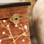 Window to the Soul Ring displayed against antique book and rustic wood background