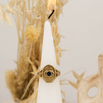  Window to the Soul ring – gold and black stone displayed on white cone with natural background