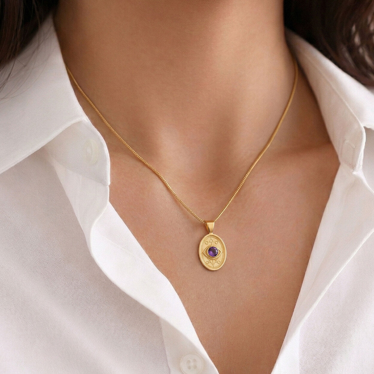  A woman wearing the Wisdom and Sefirot gold necklace, featuring geometric lines and a purple sapphire inspired by Kabbalistic wisdom.