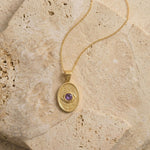 High-detail view of the geometric eye design on the Wisdom and Sefirot gold necklace, showcasing the hand-finished craftsmanship.
